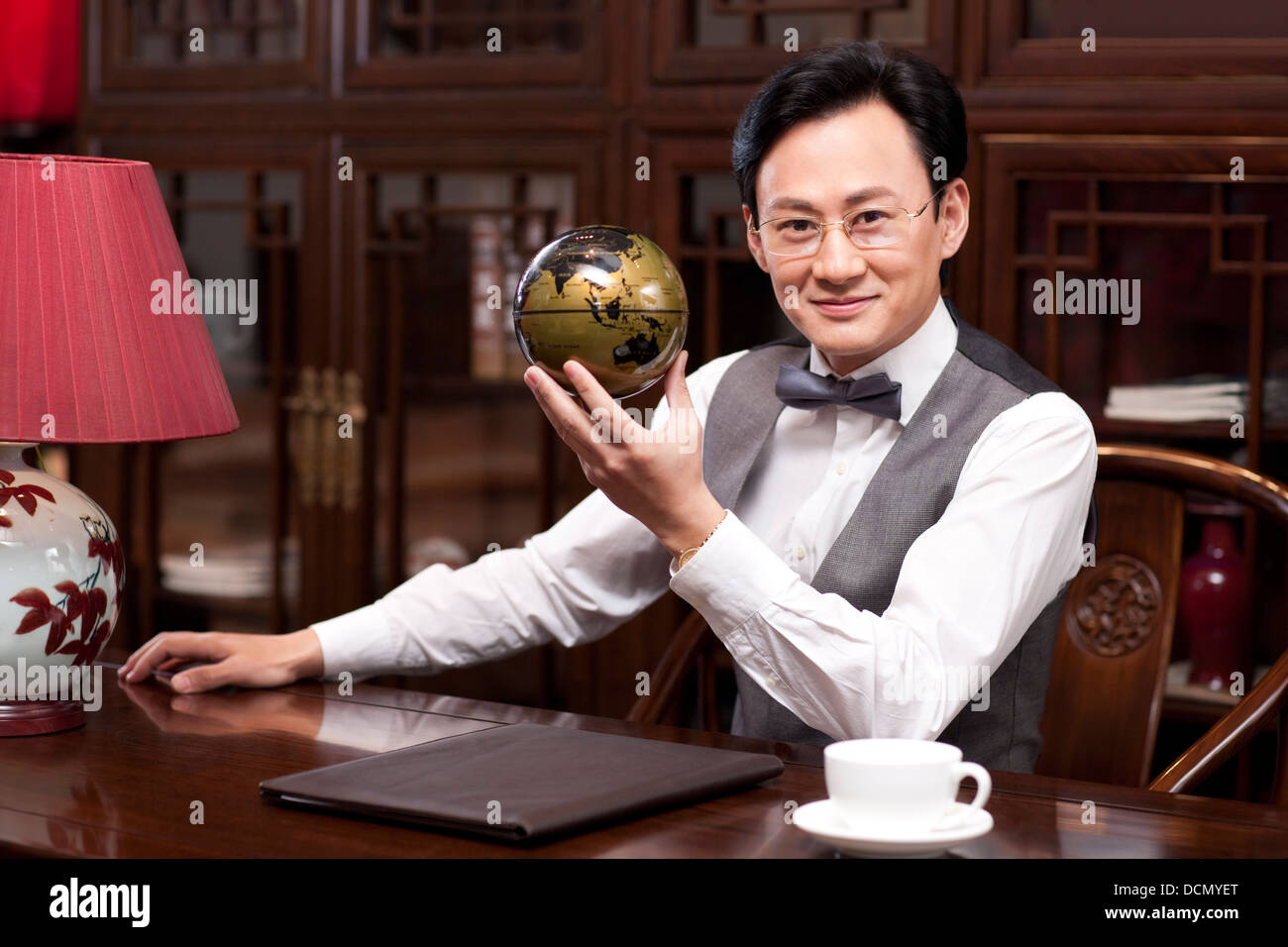 Businessman with a globe Stock Photo - Alamy
