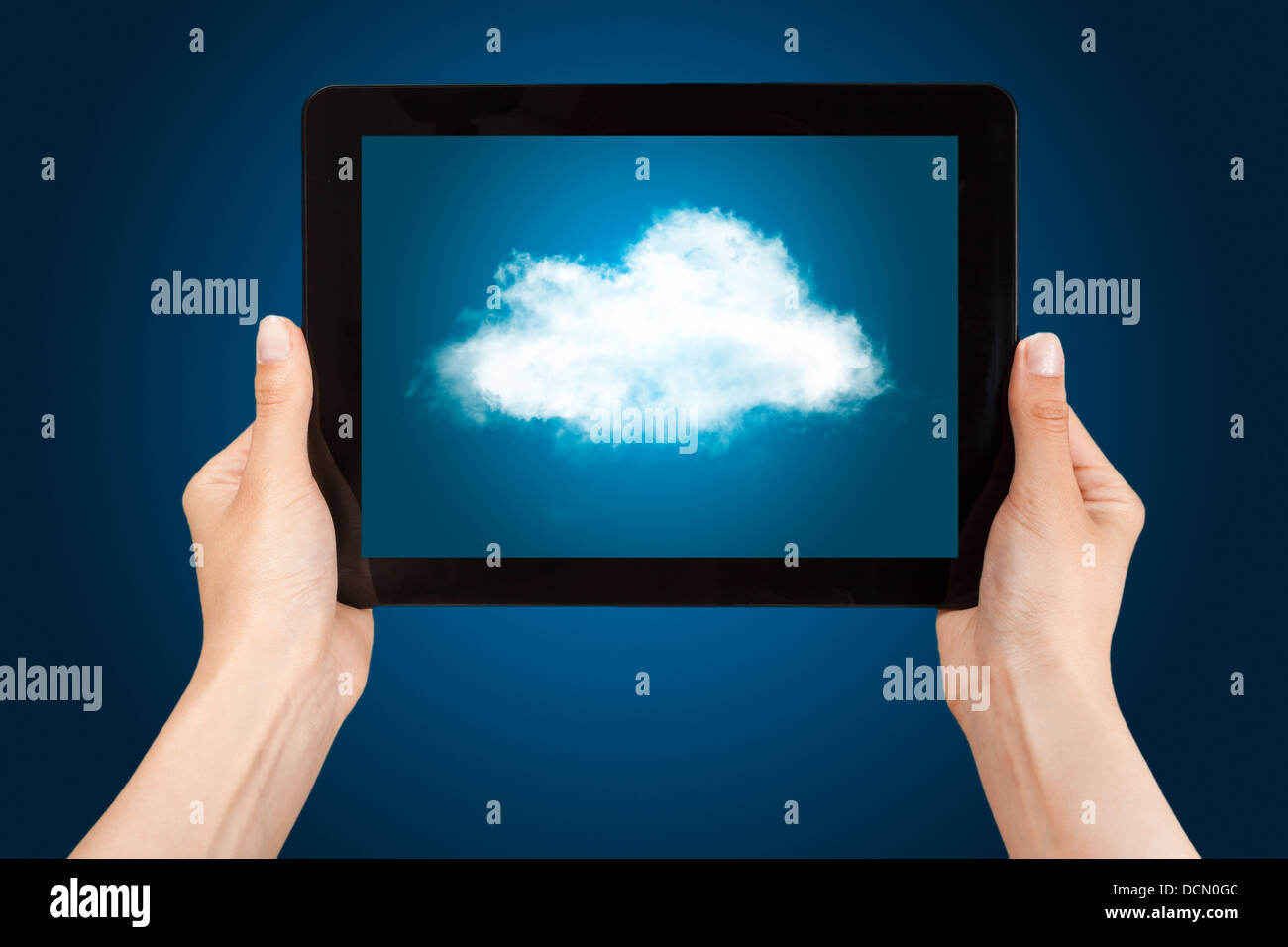 Woman hands holding tablet PC with cloud. Stock Photo