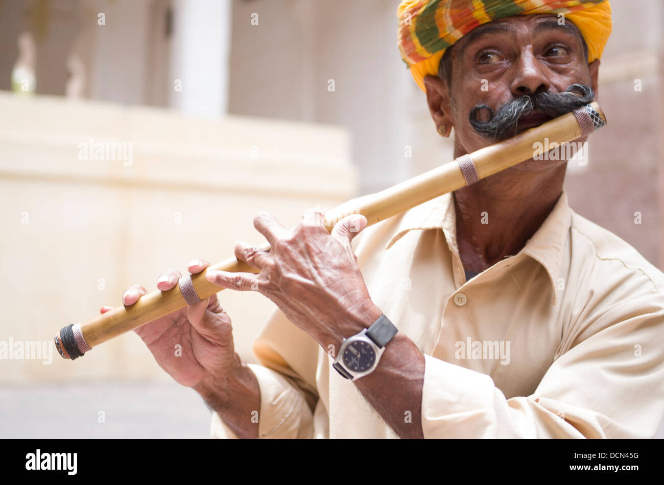 Man playing Bansuri traditional bamboo transverse flute at Meherangarh Fort - Jodhpur, Rajashtan, India Stock Photo
