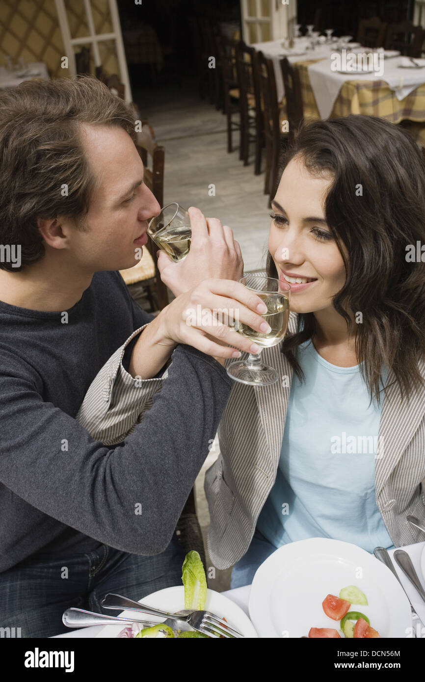Couple drinking wine with linked arms Stock Photo Alamy