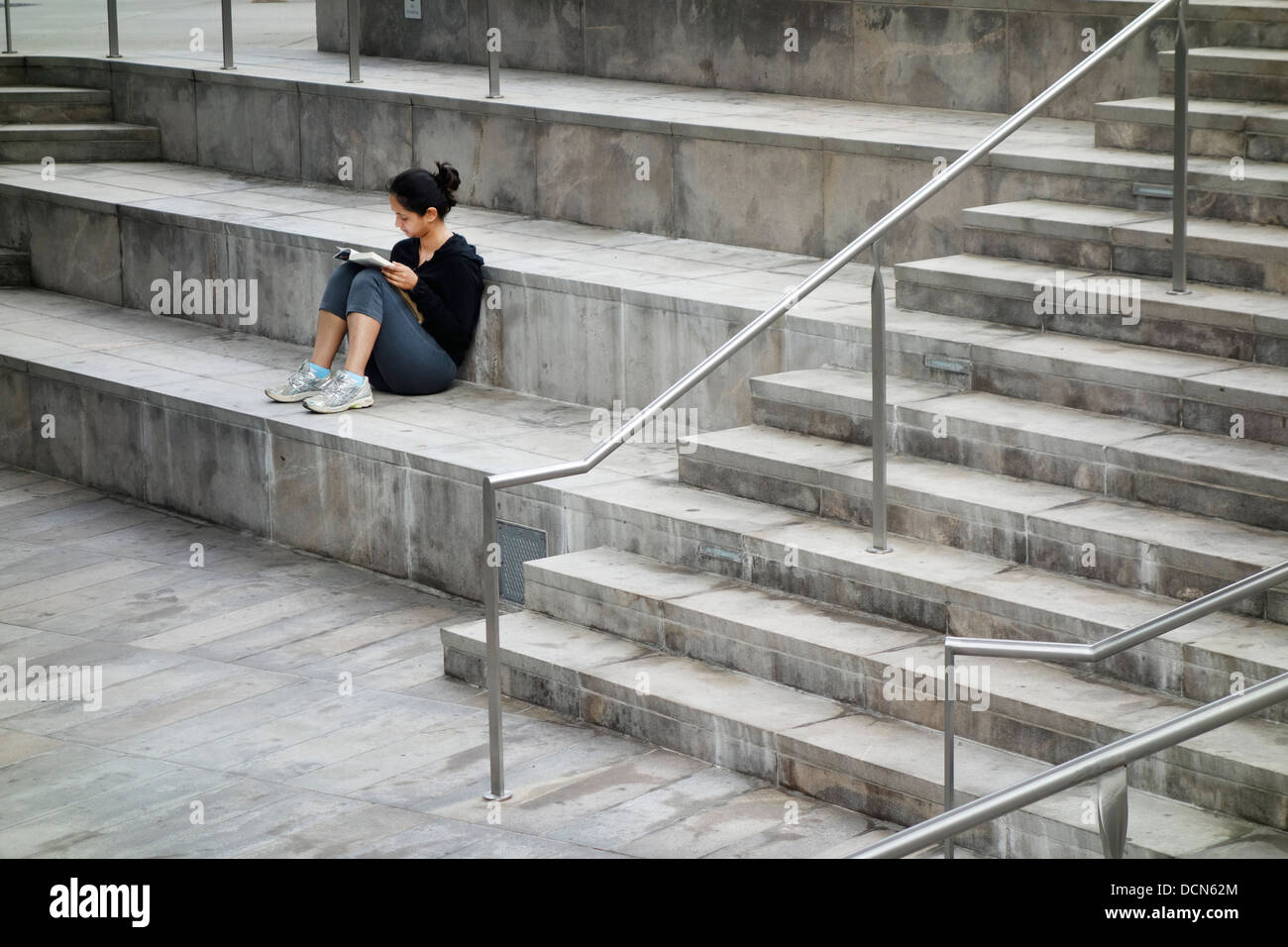 Girl on stairs reading hi-res stock photography and images - Alamy