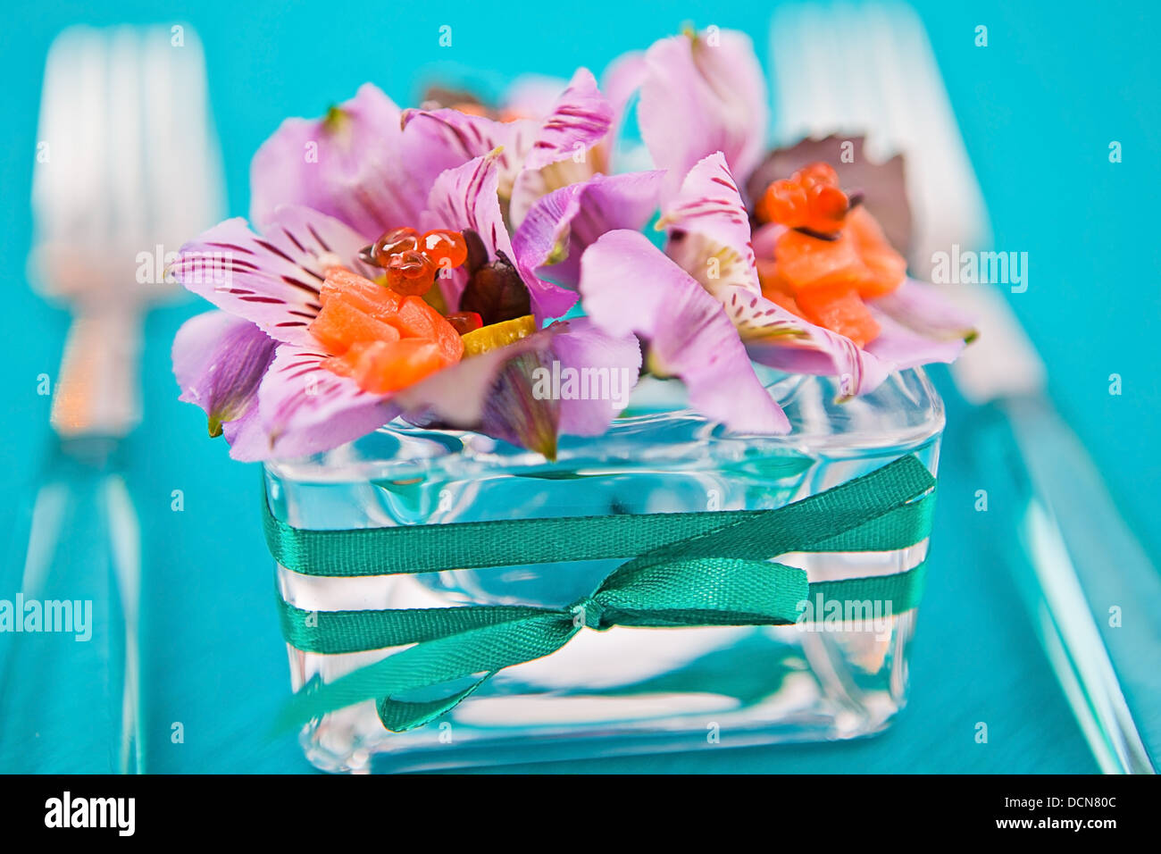 flowers in a glass dish with slices of fish Stock Photo