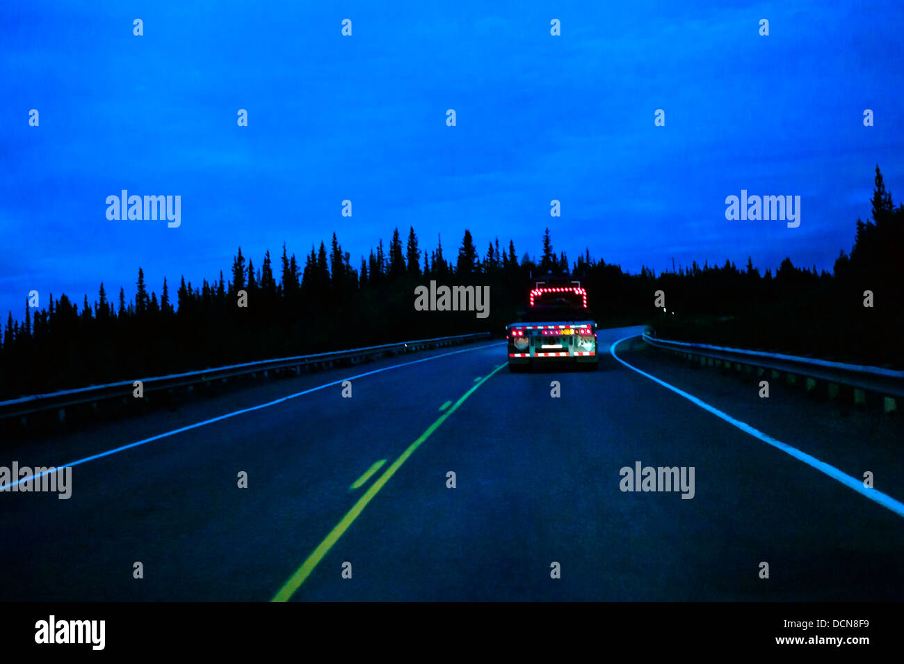 Night view of truck tail lights, Glenn Highway, Highway 1, west of Glennallen, Alaska, USA Stock