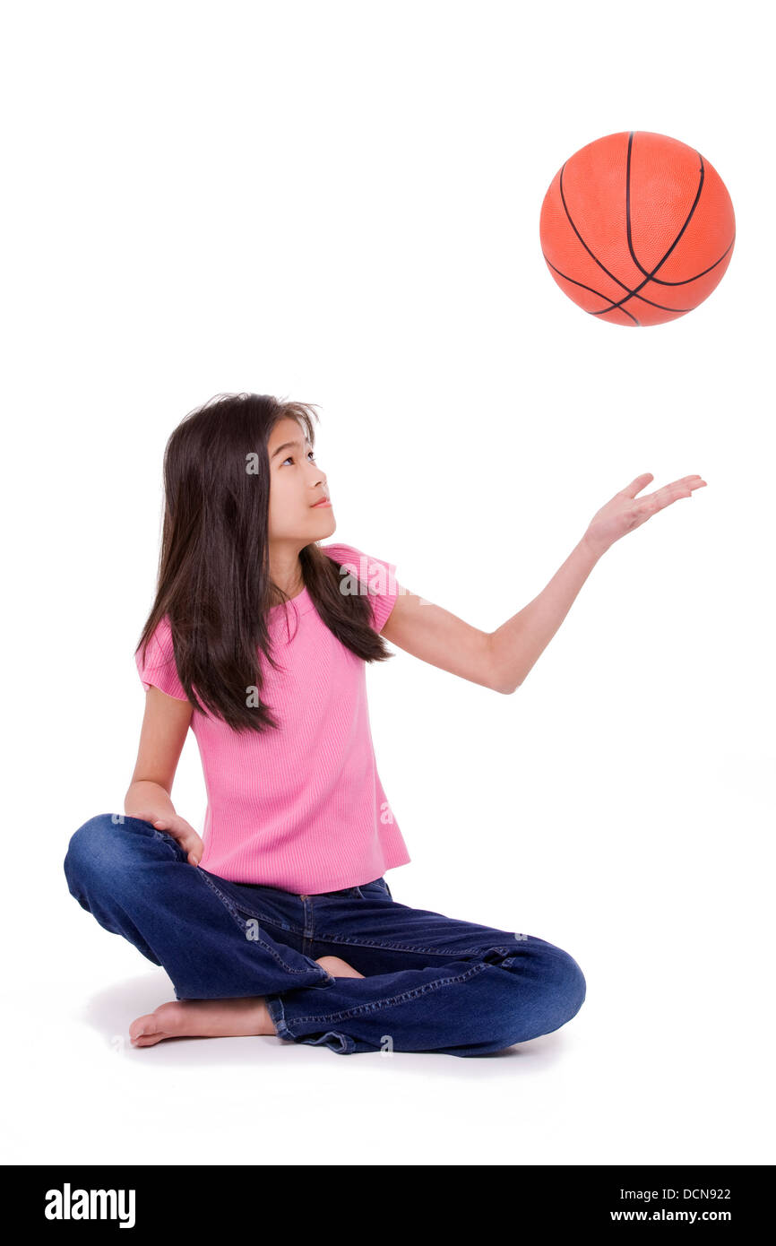 Young girl throwing basketball, isolated on white Stock Photo Alamy