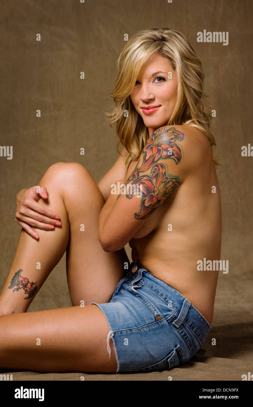 Studio portrait of tattoos on a beautiful young partially nude woman Stock Photo image