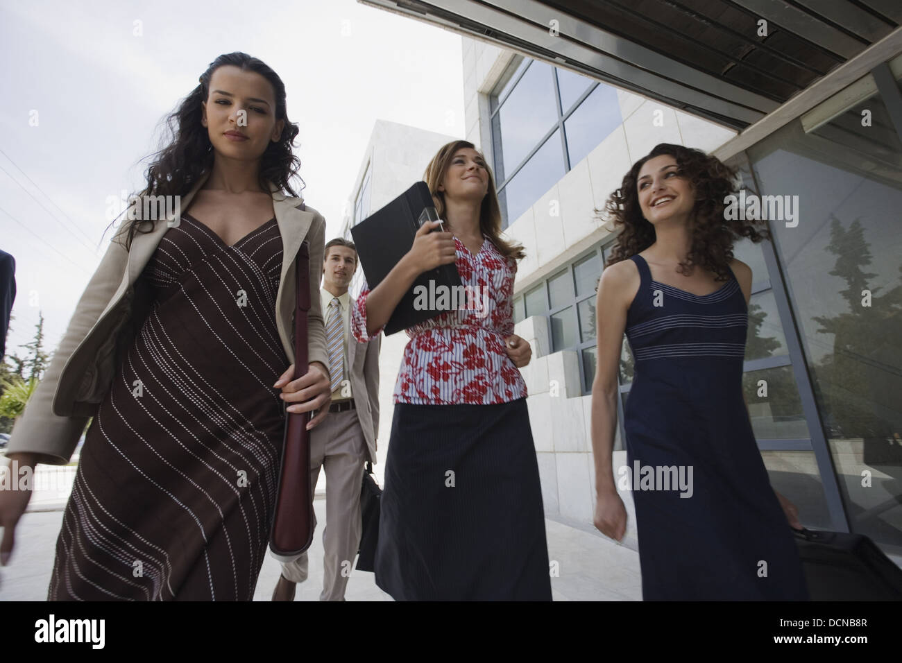 Group of business people walking Stock Photo - Alamy