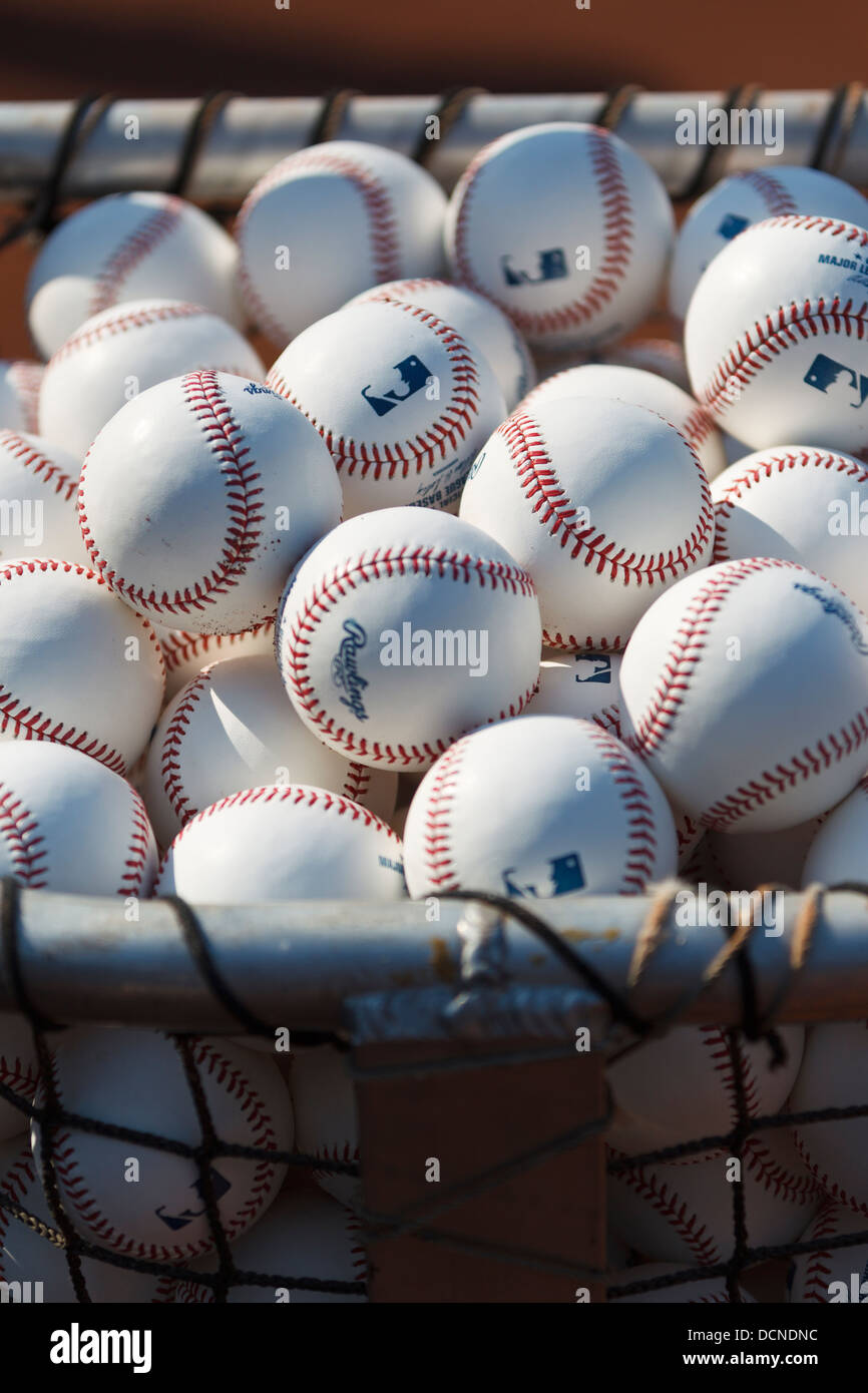 Stack of Major League Baseball baseballs on the field during batting