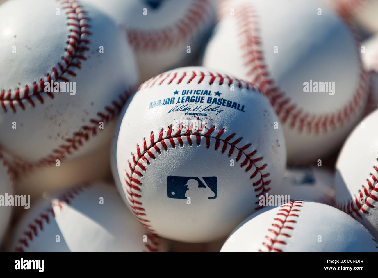 Stack of Major League Baseball baseballs on the field during batting practice before a game. Stock Photo