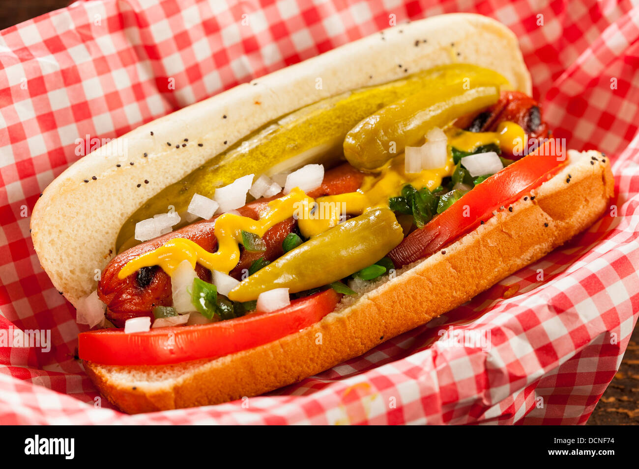 Chicago Style Hot Dog with Mustard, Pickle, Tomato, Relish and Onion Stock Photo