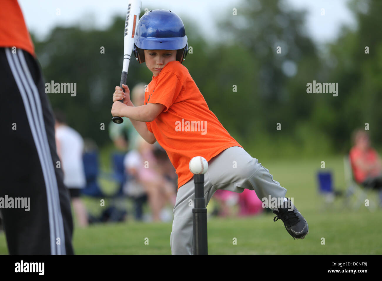 Young boy hitting t-ball Stock Photo