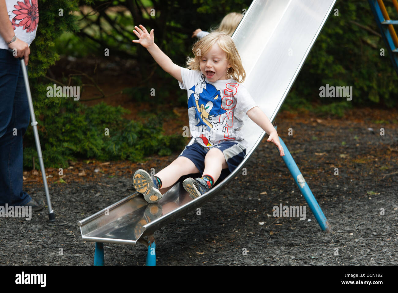 A boy going down a slide Stock Photo Alamy