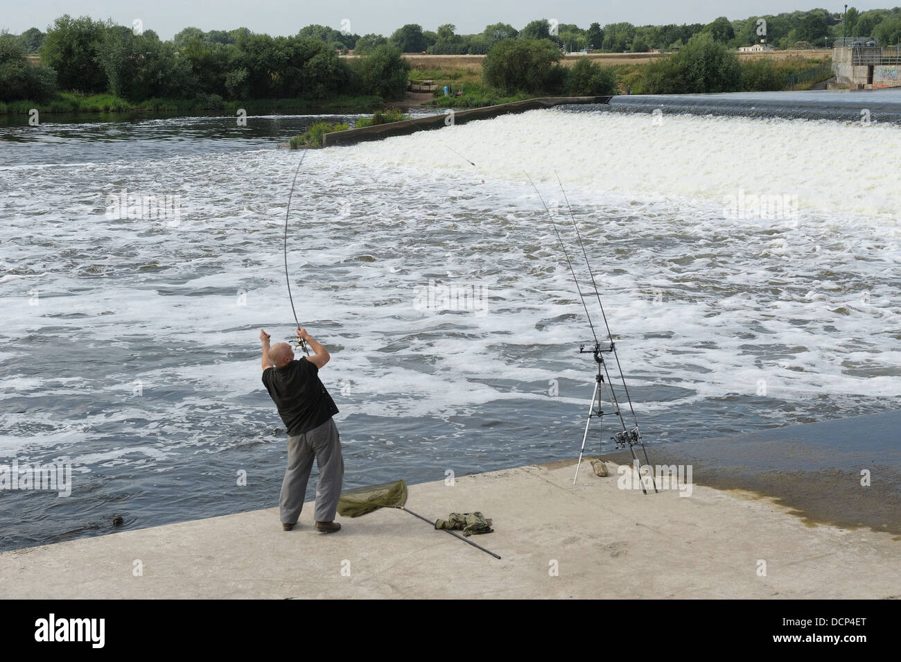 A man casting a fishing line Beeston weir Nottingham England uk Stock Photo