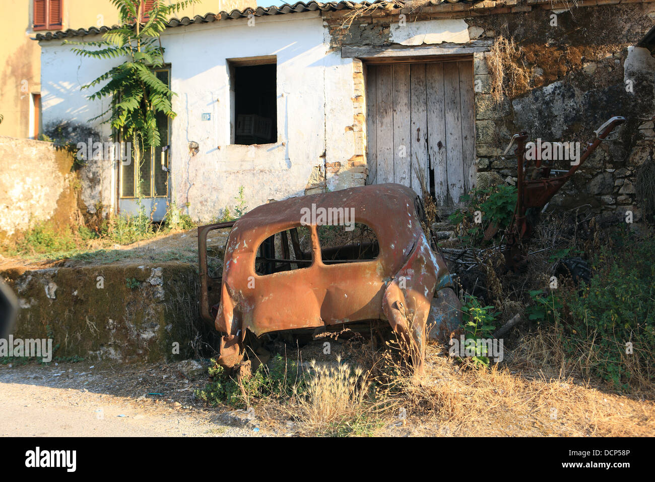 Rusty abandoned car outside a run down building in Corfu Greece Stock ...