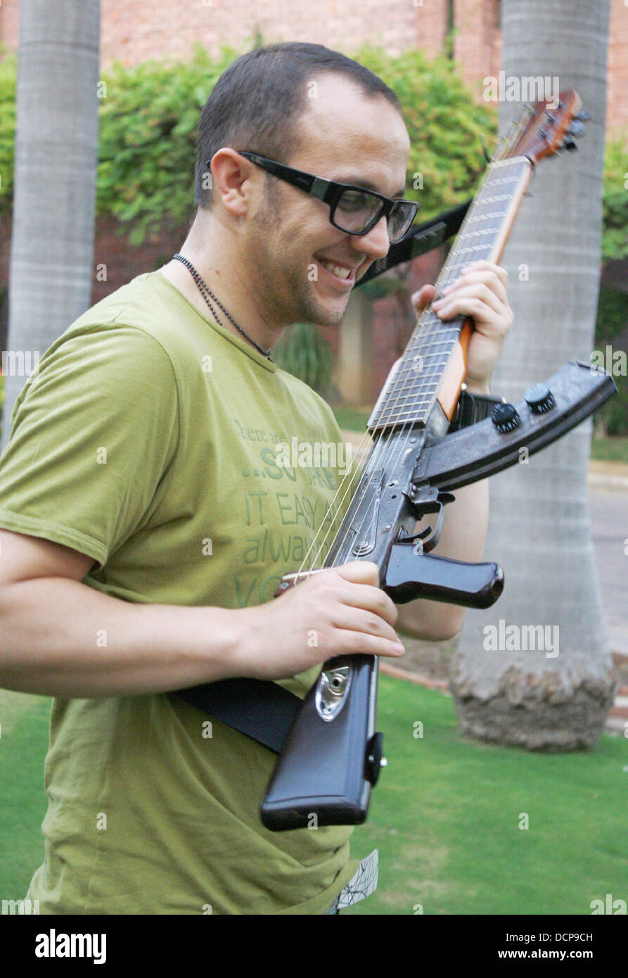 Colombian musician, Cezar Lopez poses with his AK47 "gunguitar". The