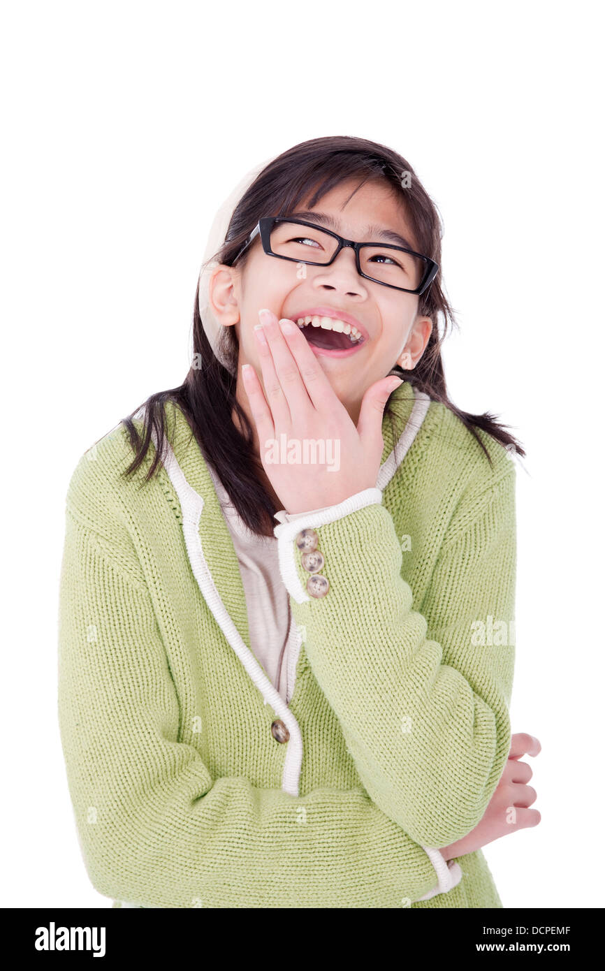 Girl in green sweater and glasses looking up and covering a laug Stock Photo