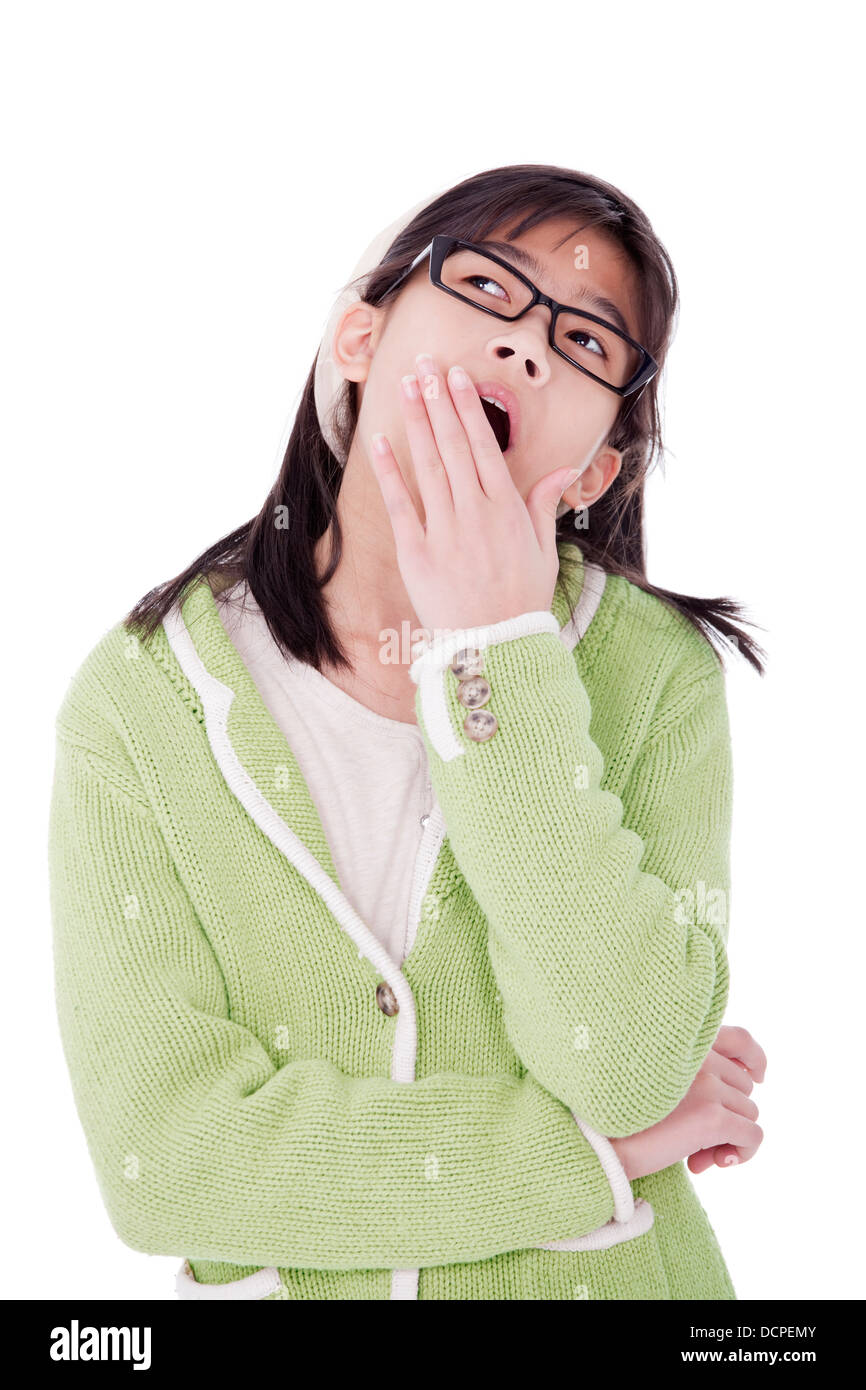 Girl in green sweater and glasses looking up, yawning Stock Photo