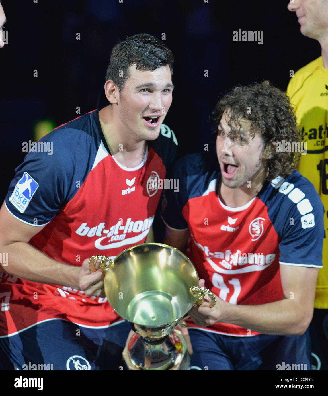 Bremen, Germany. 20th Aug, 2013. Flensburg's Drasko Nenadic and Bogdan Radivojevic hold the trophy of the DHB handball supercup after the match THW Kiel vs. SG Flensburg-Handewitt held at OEVB-Arena in Bremen, Germany, 20 August 2013. Photo: Carmen Jaspersen/dpa/Alamy Live News Stock Photo