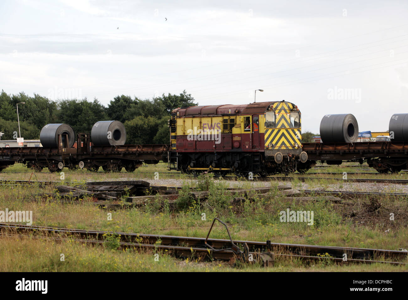 Shunting Yard at Tata Steel, Port Talbot, Wales, UK, with rolls of steel ready for transportation visible on rolling stock in the background Stock Photo