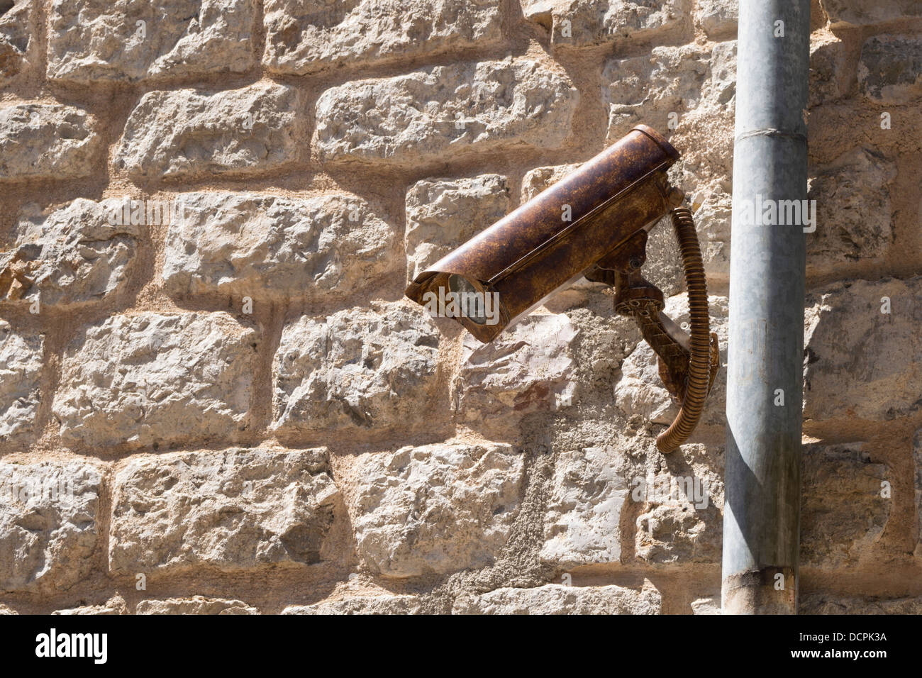 outdoor surveillance camera with ancient stone wall background Stock Photo