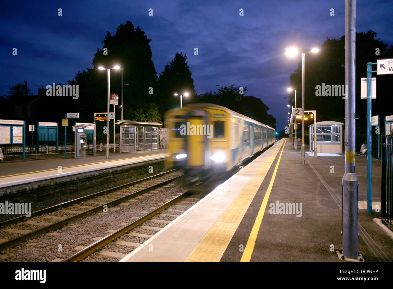 Train Arrives at Gowerton Station on the West Wales line at twilight Stock Photo