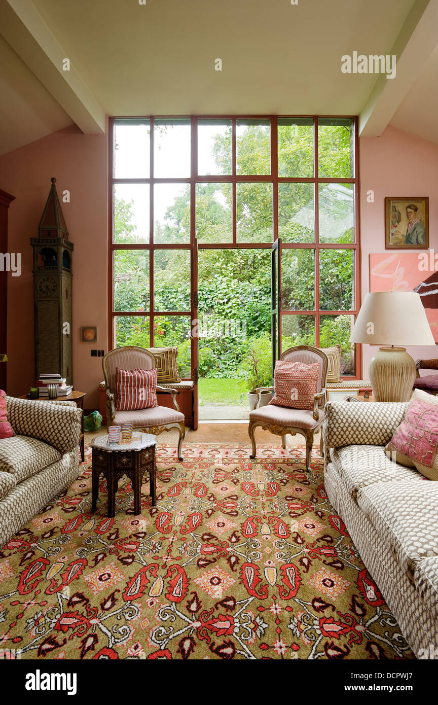 Lounge with large windows looking out onto garden Stock Photo
