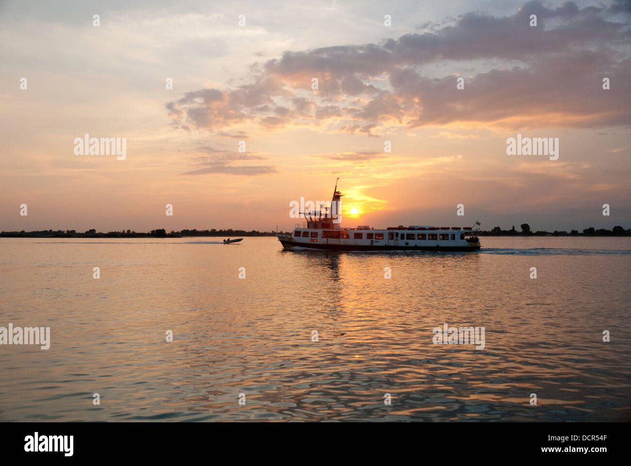 Passenger boat on the Venice Lagoon at sunset Stock Photo - Alamy