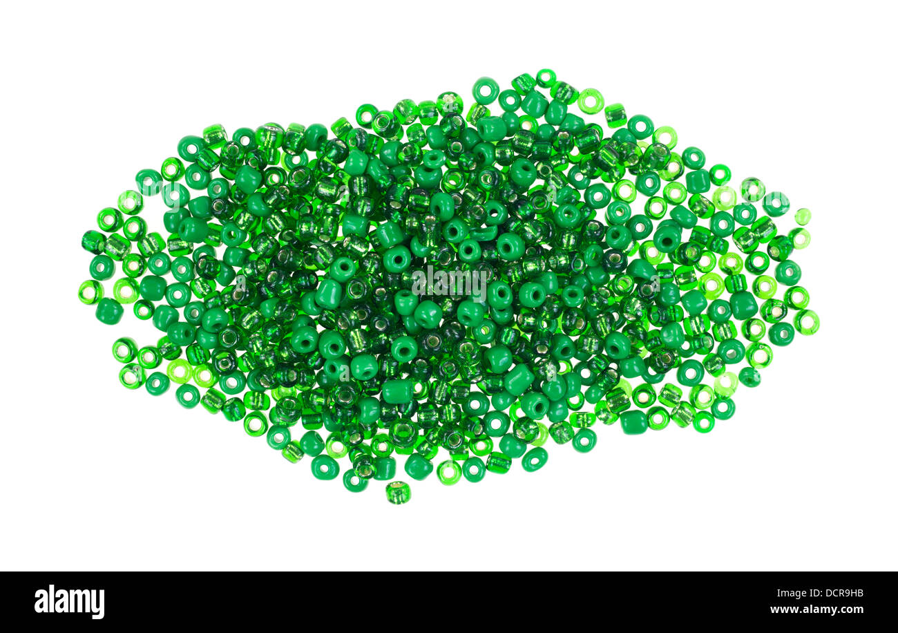 A small pile of green glass beads used in arts and crafts on a white background. Stock Photo