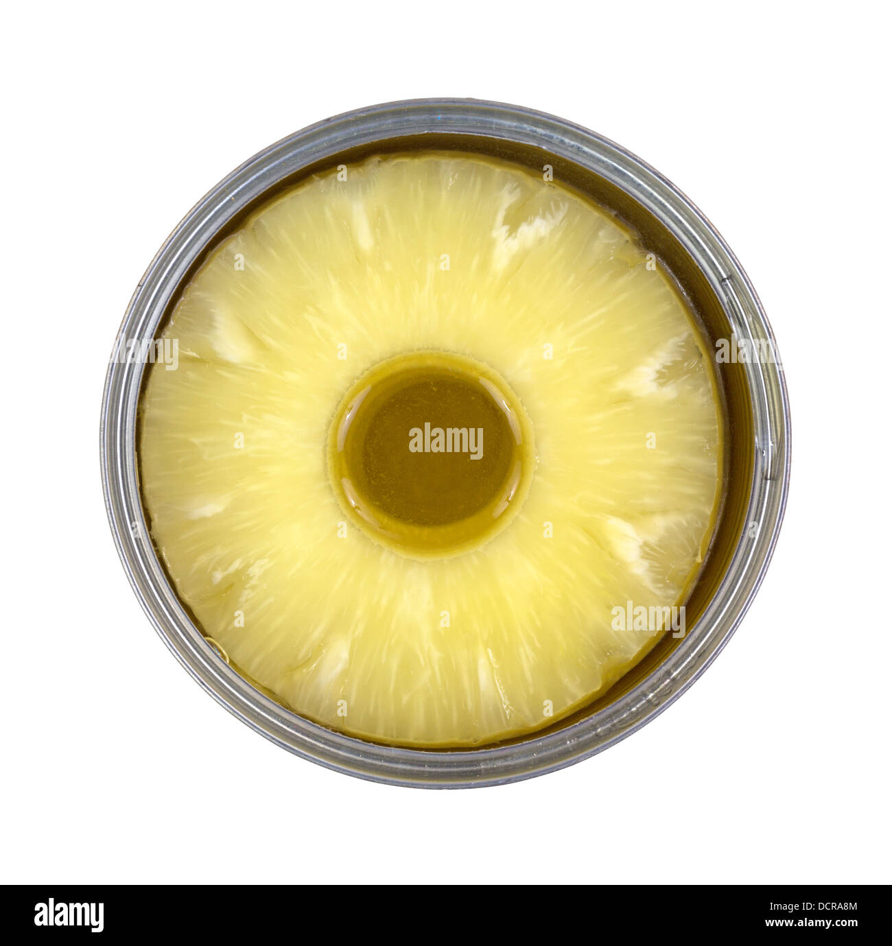 Top view of a tin can filled with cored pineapple rings on a white background. Stock Photo