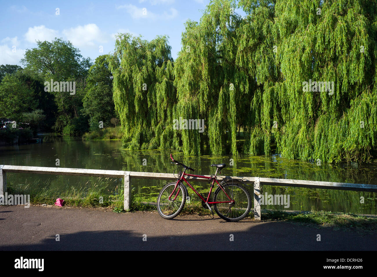 A red bicycle parked by the River Cam, Cambridge, UK Stock Photo