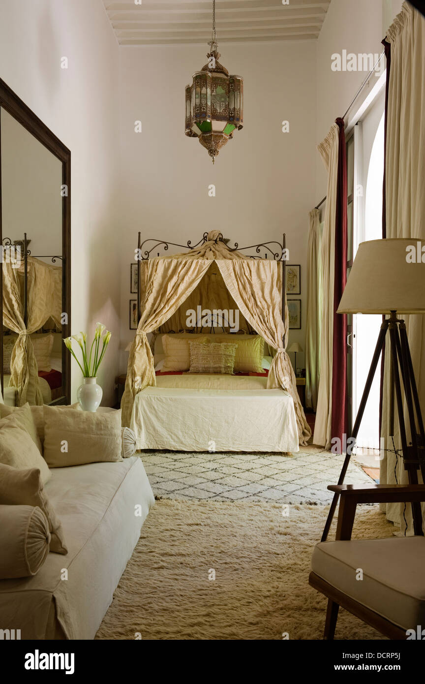 Moroccan Style Bedroom With High Beamed Ceiling And Cream Coloured