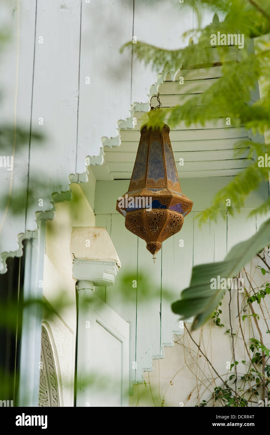 Rusted Moroccan lamp in paneled Moroccan courtyard Stock Photo