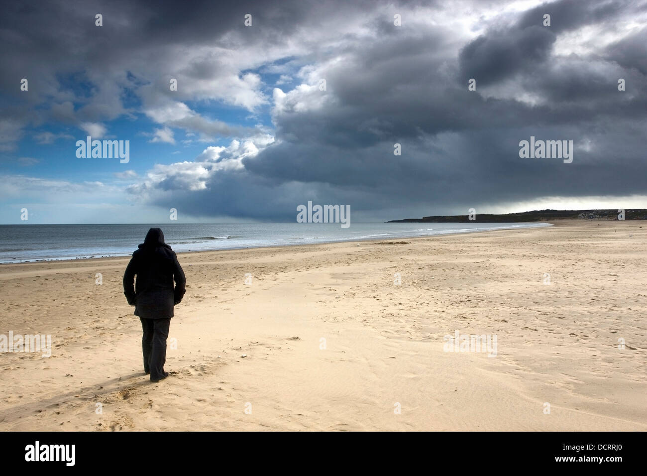 A Person Alone Walking On The Beach Stock Photo - Alamy