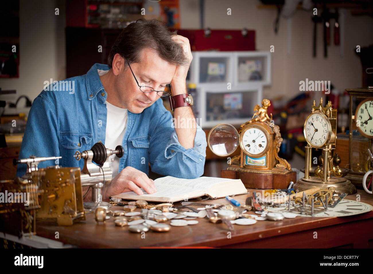 A Clock Maker And Repairman Reading His Bible In His Shop; St