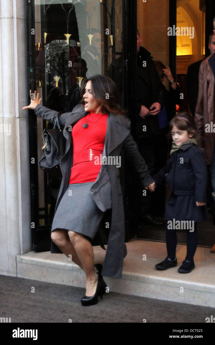 Salma Hayek loses her footing and falls over as she leaves the Four