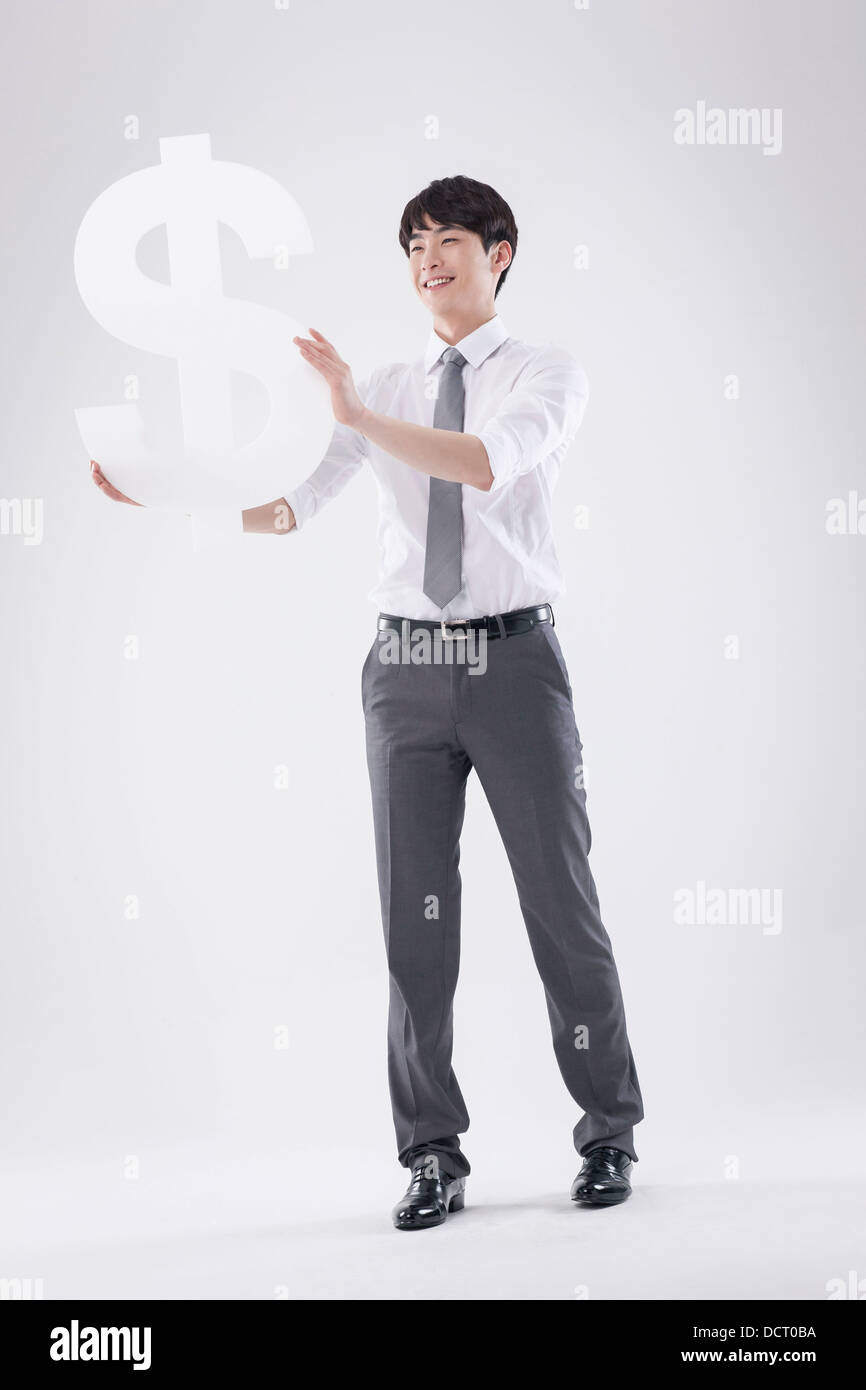 a business man holding a dollar sign Stock Photo - Alamy