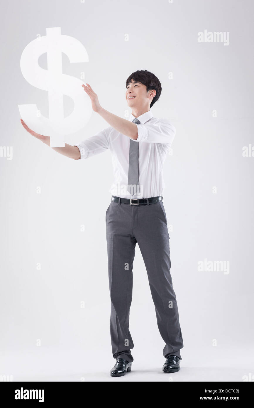 a business man holding a dollar sign Stock Photo - Alamy