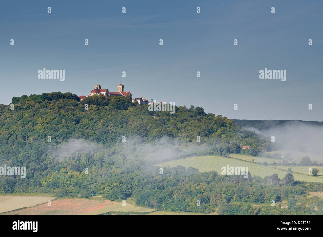 Mist clears away from around the hilltop village of Vezelay in the Yonne area of Burgundy. Stock Photo