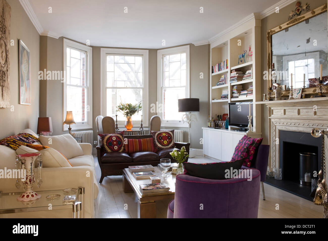 White Andrew Morton sofa in living room with assorted antique seating