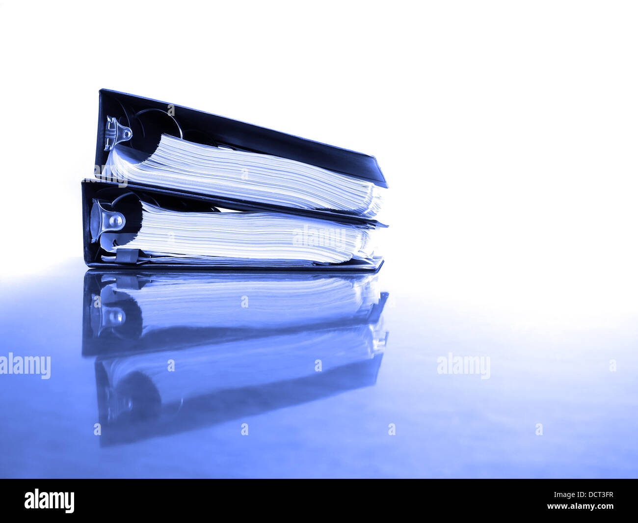 Office desk with business binders full of papers Stock Photo