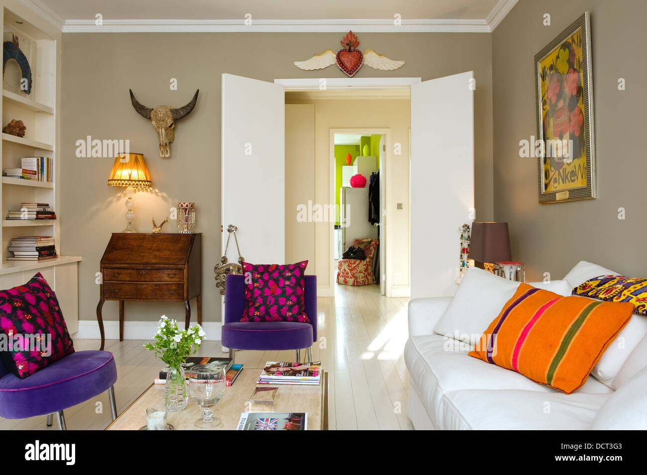 White Sofa By Andrew Morton With Orange Cushion In Living
