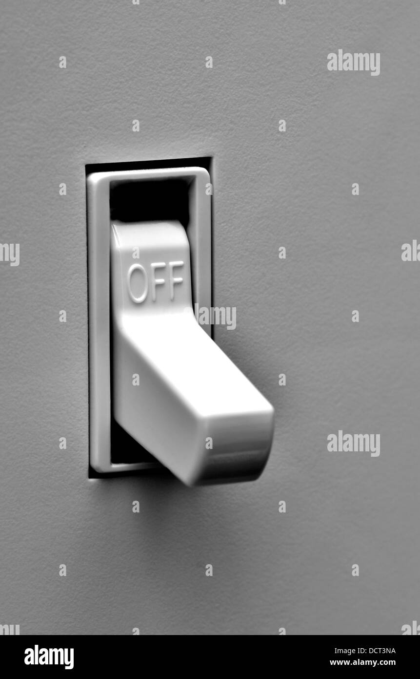 Light switch on wall inside a home in off position Stock Photo