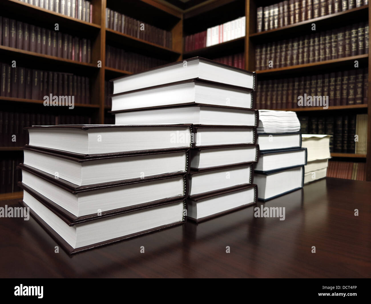 Stack of old books on a desk or table in a library Stock Photo
