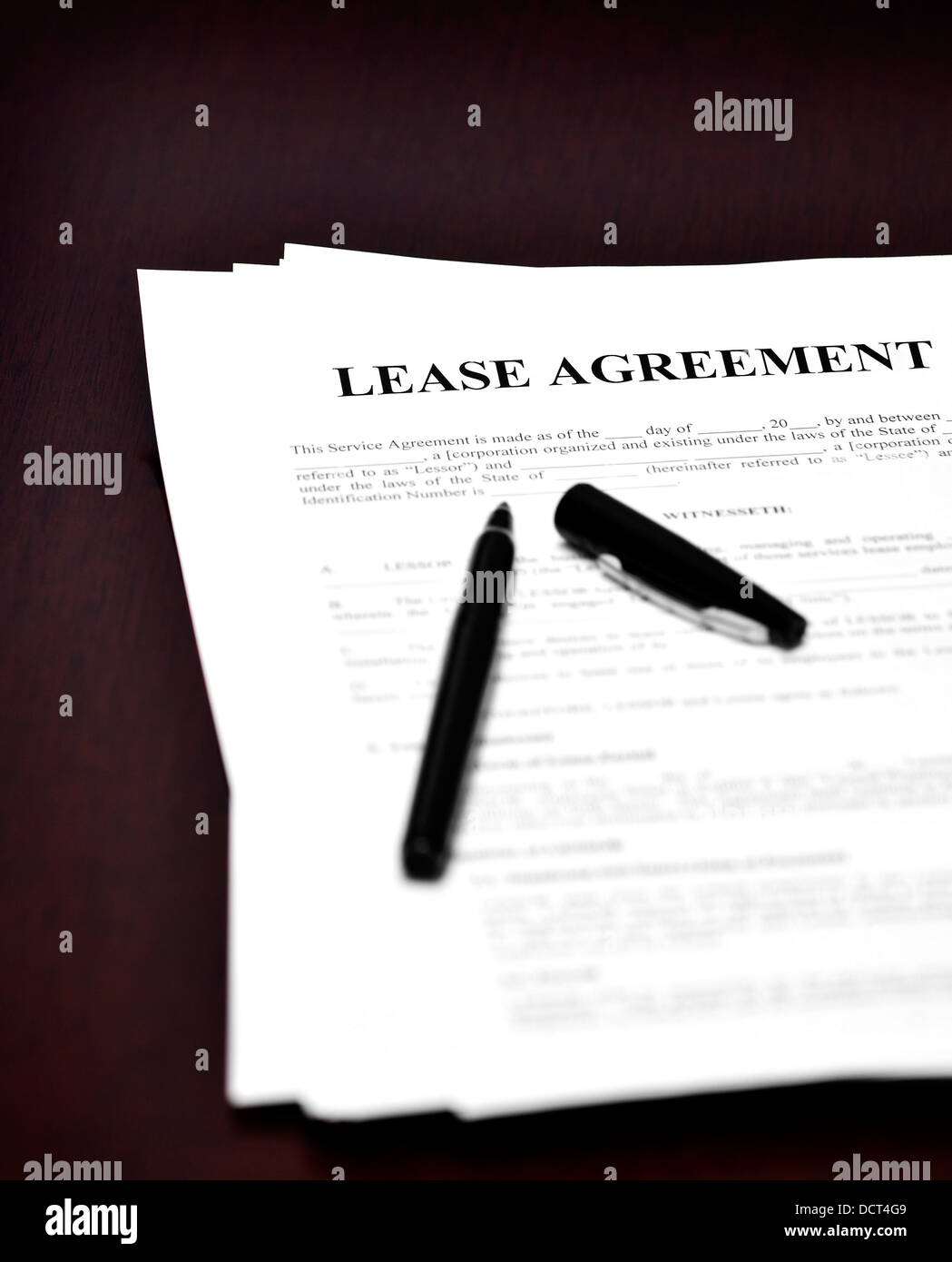 Lease Agreement on desk with black pen waiting to be signed Stock Photo