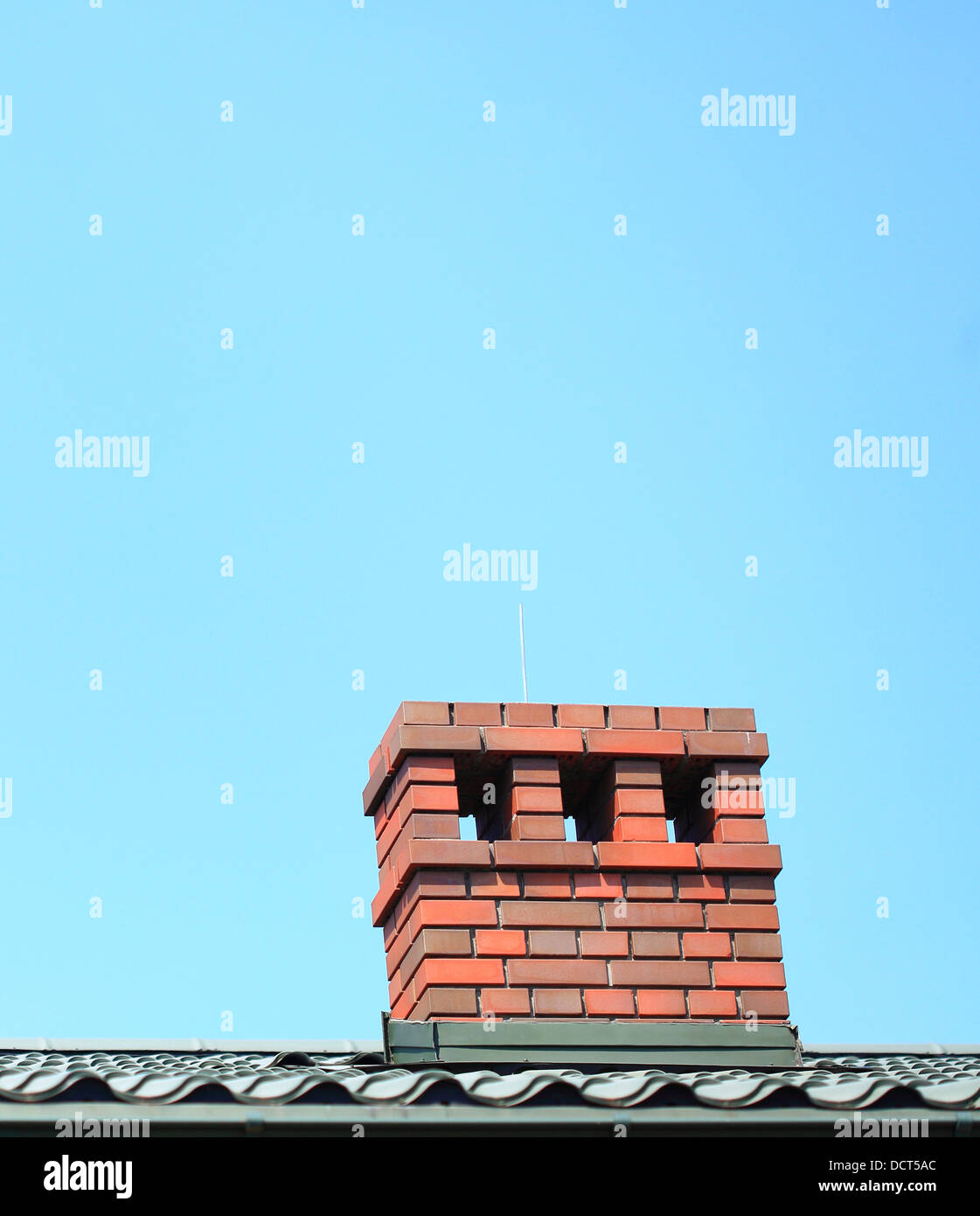 Red chimney on the roof blue sky background Stock Photo Alamy