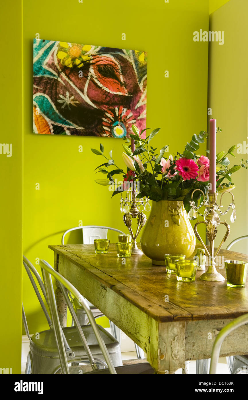 Kitchen table with bold lime green painted walls Stock Photo