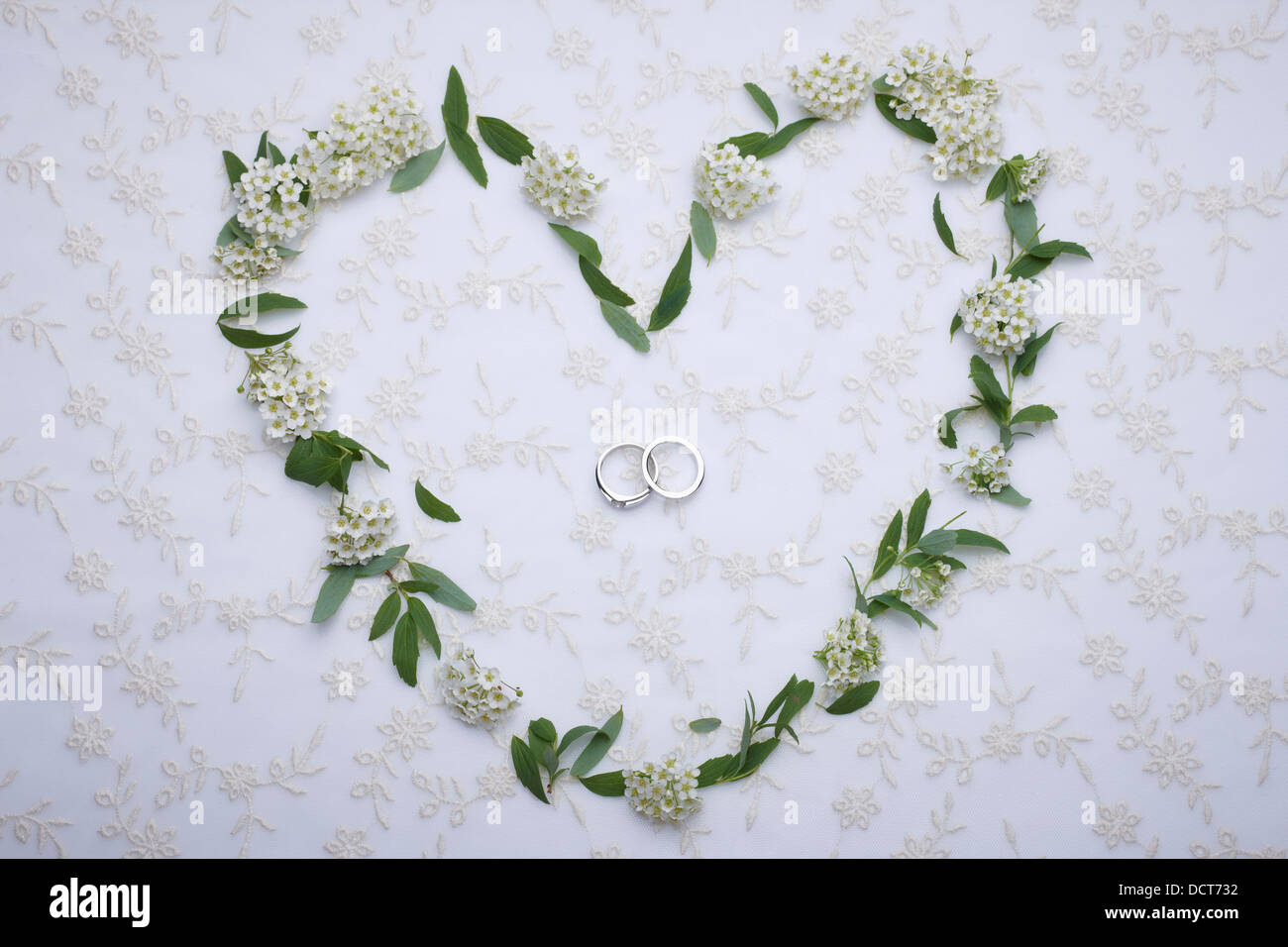 wedding rings inside flowers in a heart shape Stock Photo - Alamy
