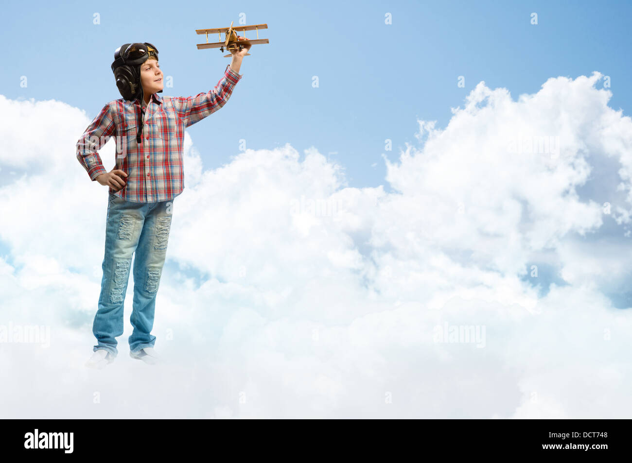 Boy in helmet pilot playing with a toy airplane Stock Photo - Alamy