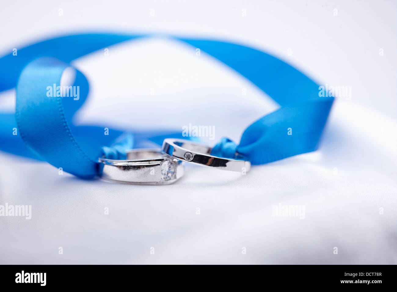 wedding rings in a blue ribbon Stock Photo - Alamy