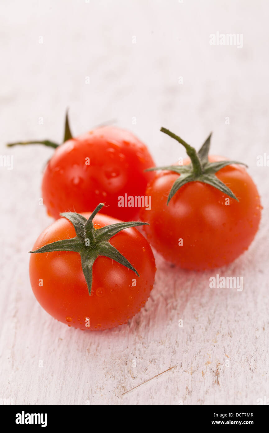 Cherry tomatoes on a white background Stock Photo - Alamy