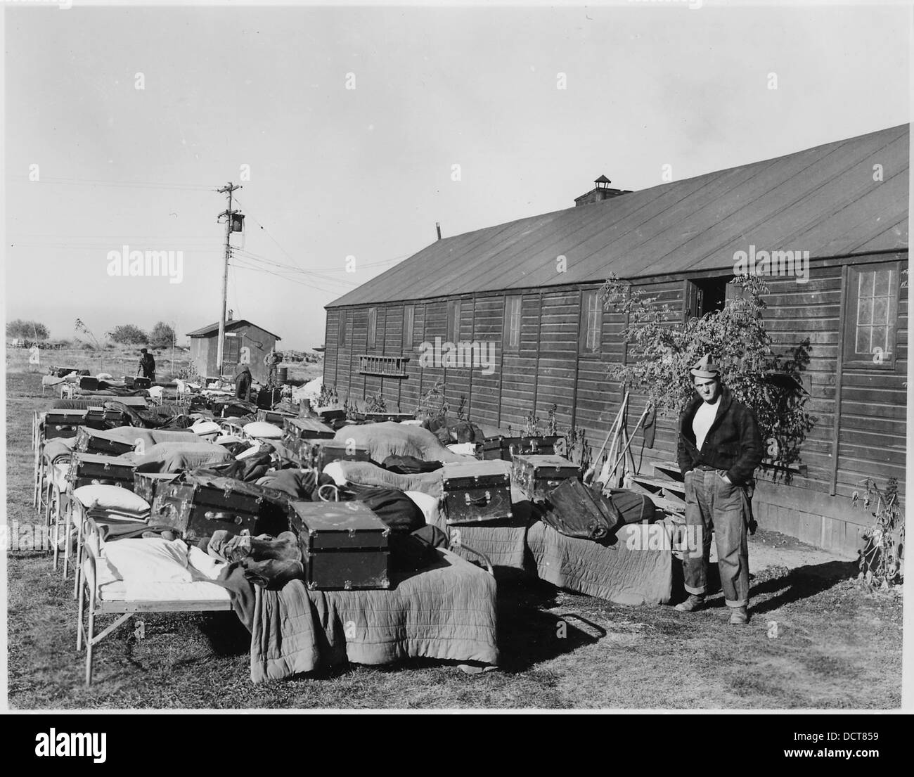 CCC Camp BR-73 Boise Project, Photo showing enrollees airing cots and wearing apparel on camp lawn. - - 293558 Stock Photo